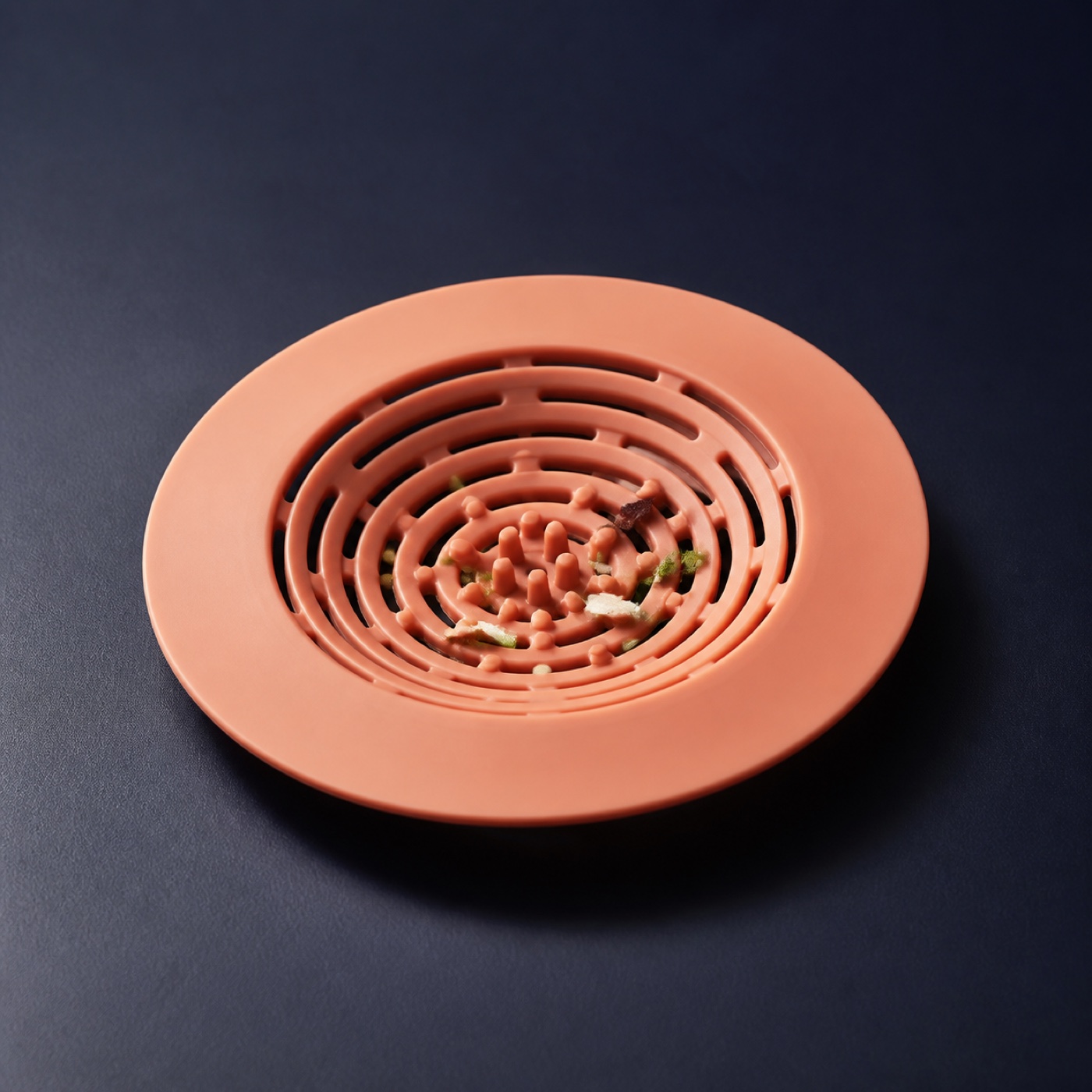A flexible silicone strainer designed to sit over a sink plughole